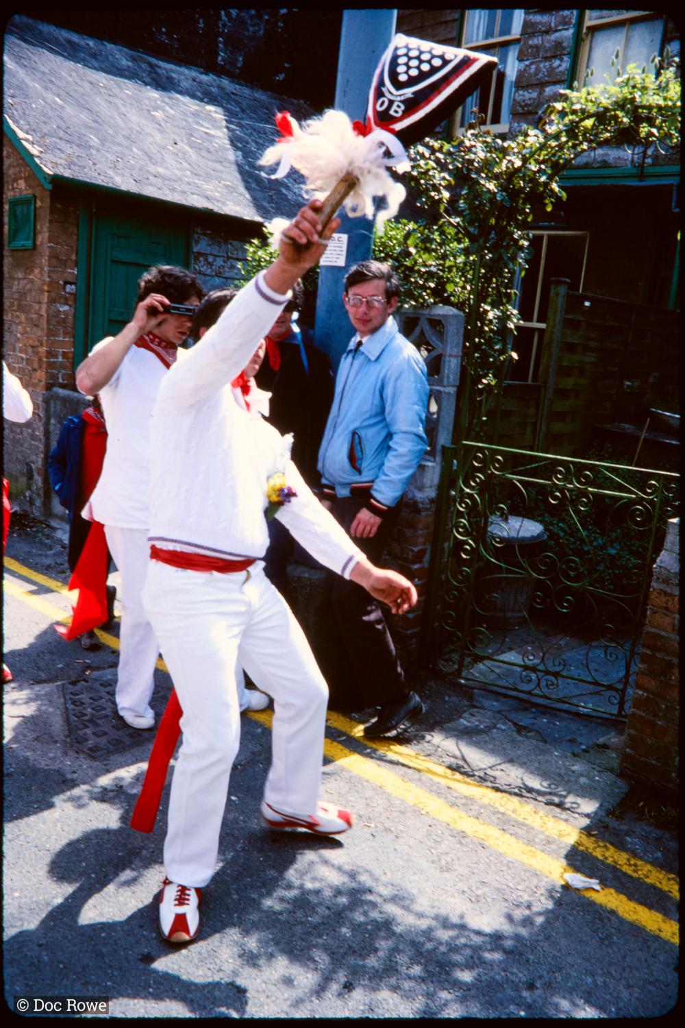Man holding club up teasing Old Oss