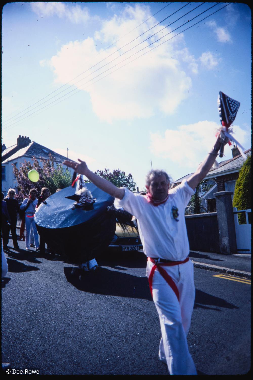 Man holding club up to sky