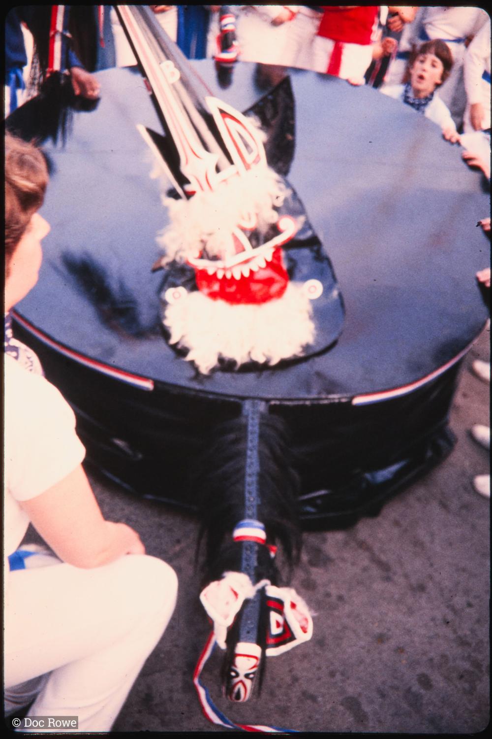 People kneeling down with Blue Ribbon Oss