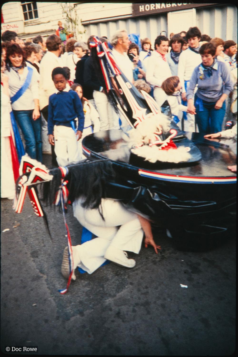 Someone crawling under Blue Ribbon Oss costume