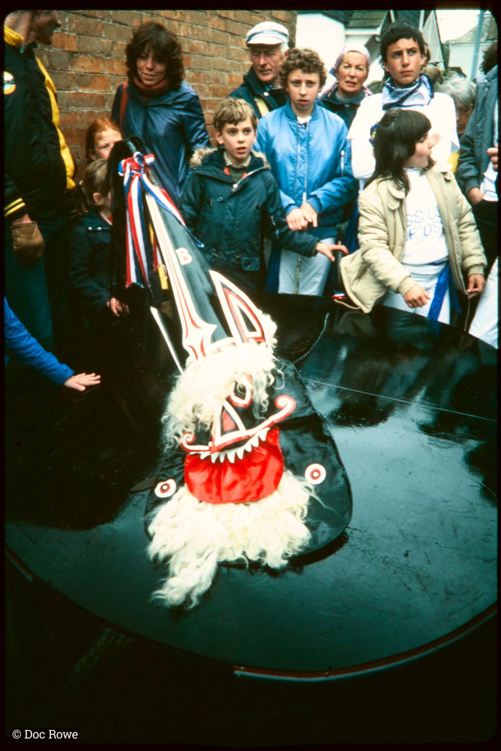 Blue Ribbon with children crowded around