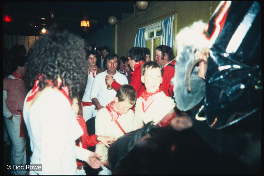 Children crowded around Old Oss in pub