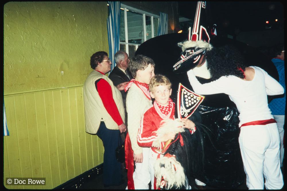 Child holding Old Oss club in pub