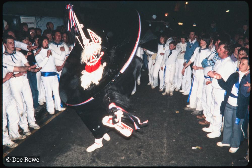 Blue Ribbon dancing at night with crowd watching