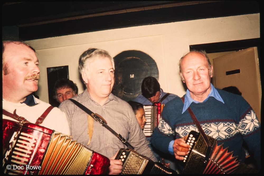 Men playing accordions in pub