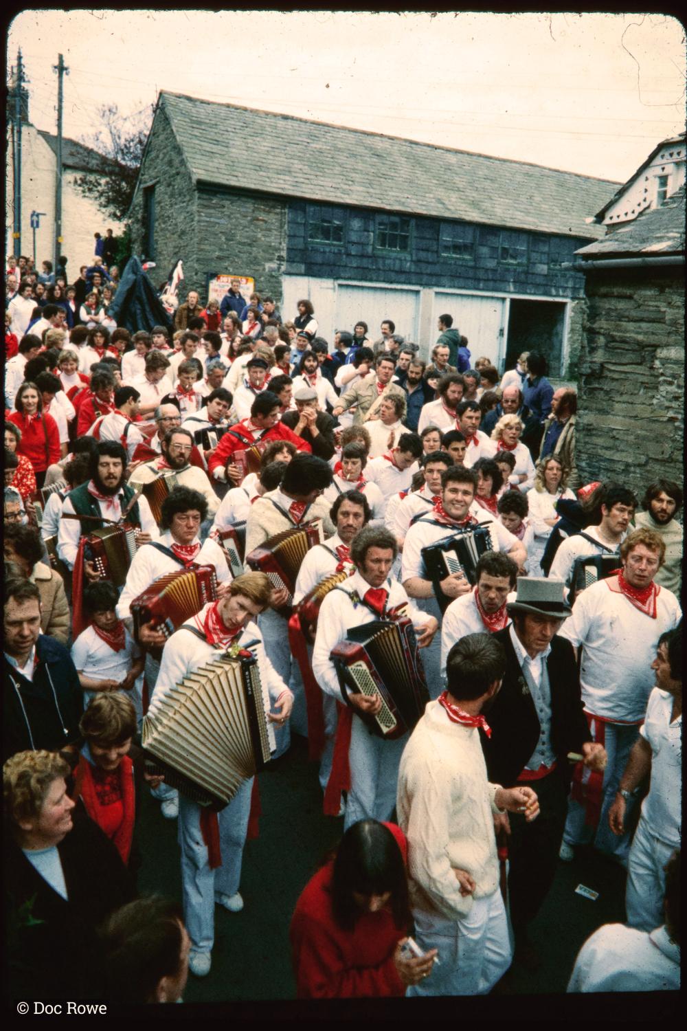Old Oss band, with Master of Ceremonies, walking down road