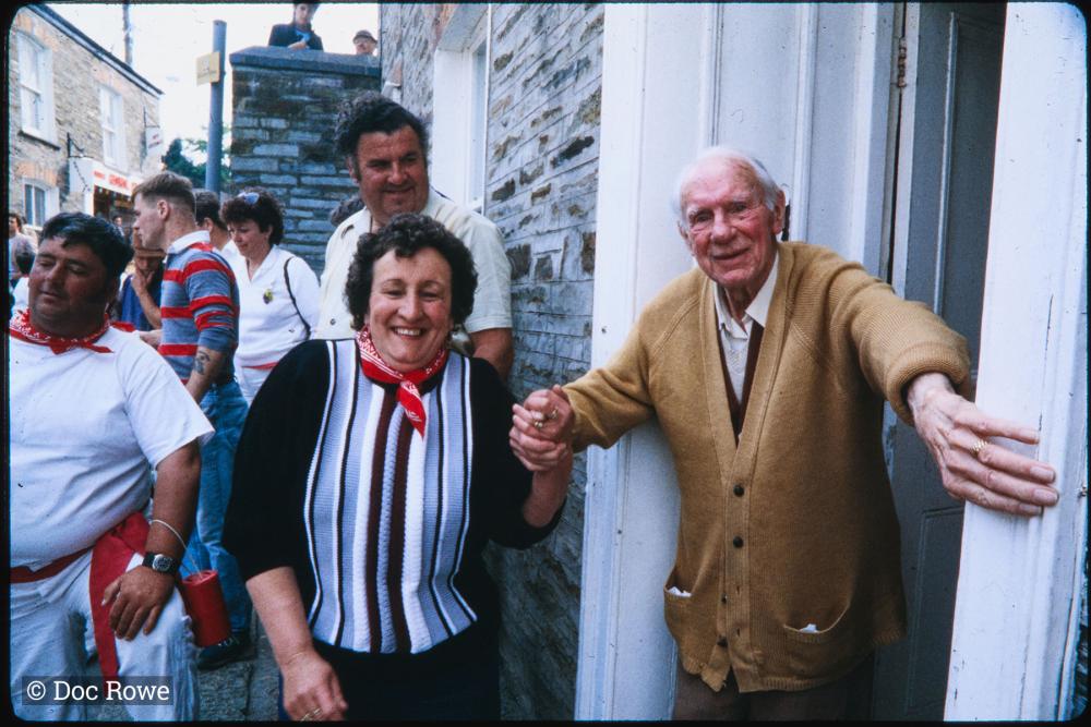 Man watching procession from his front door