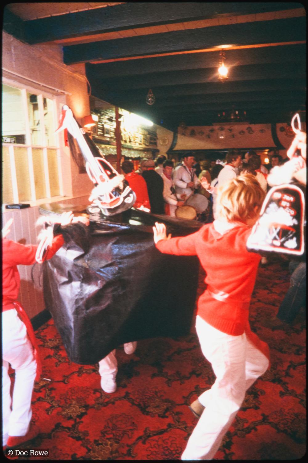 Children dancing with Old Oss in pub