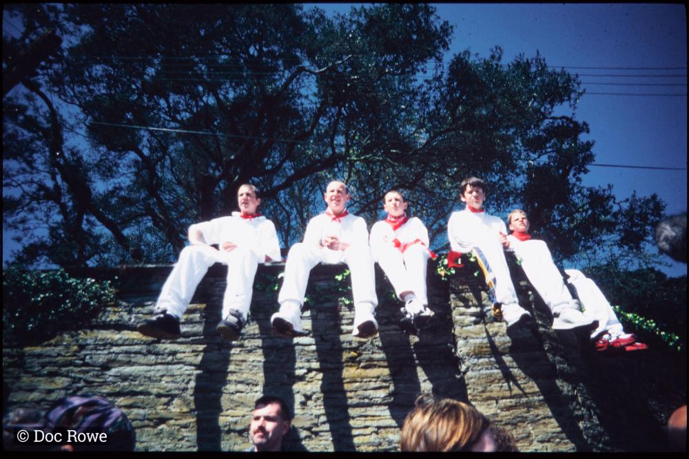 Boys from Old Oss sitting on wall in sun