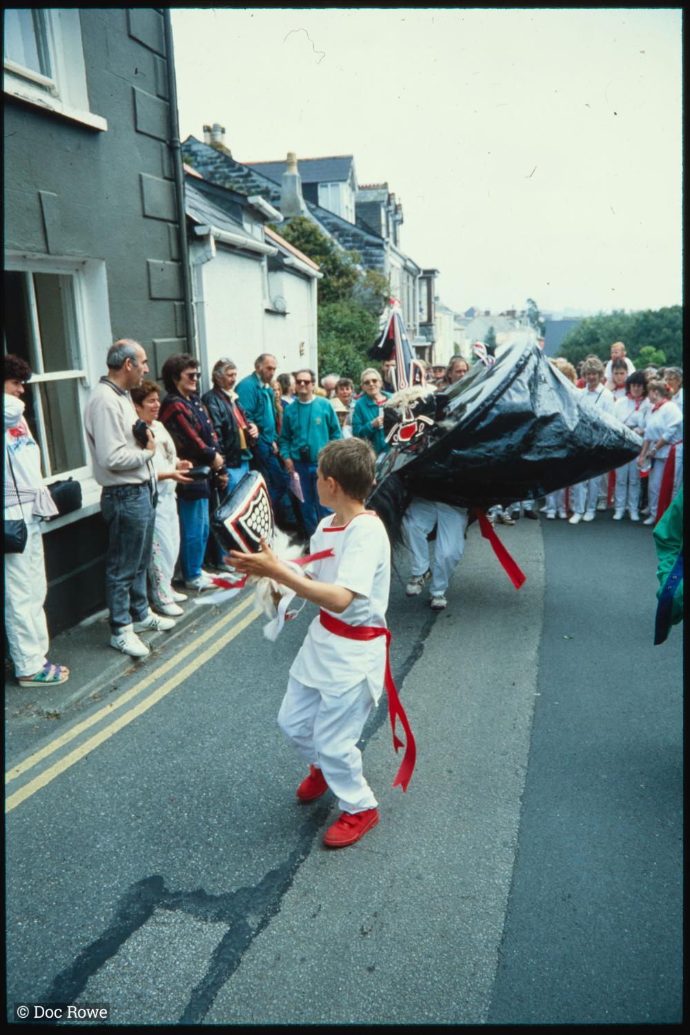 Boy teasing Old Oss in road