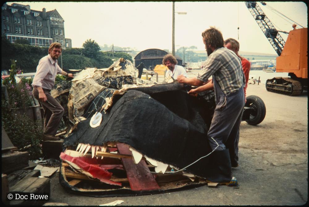 Men deconstructing carnival whale 